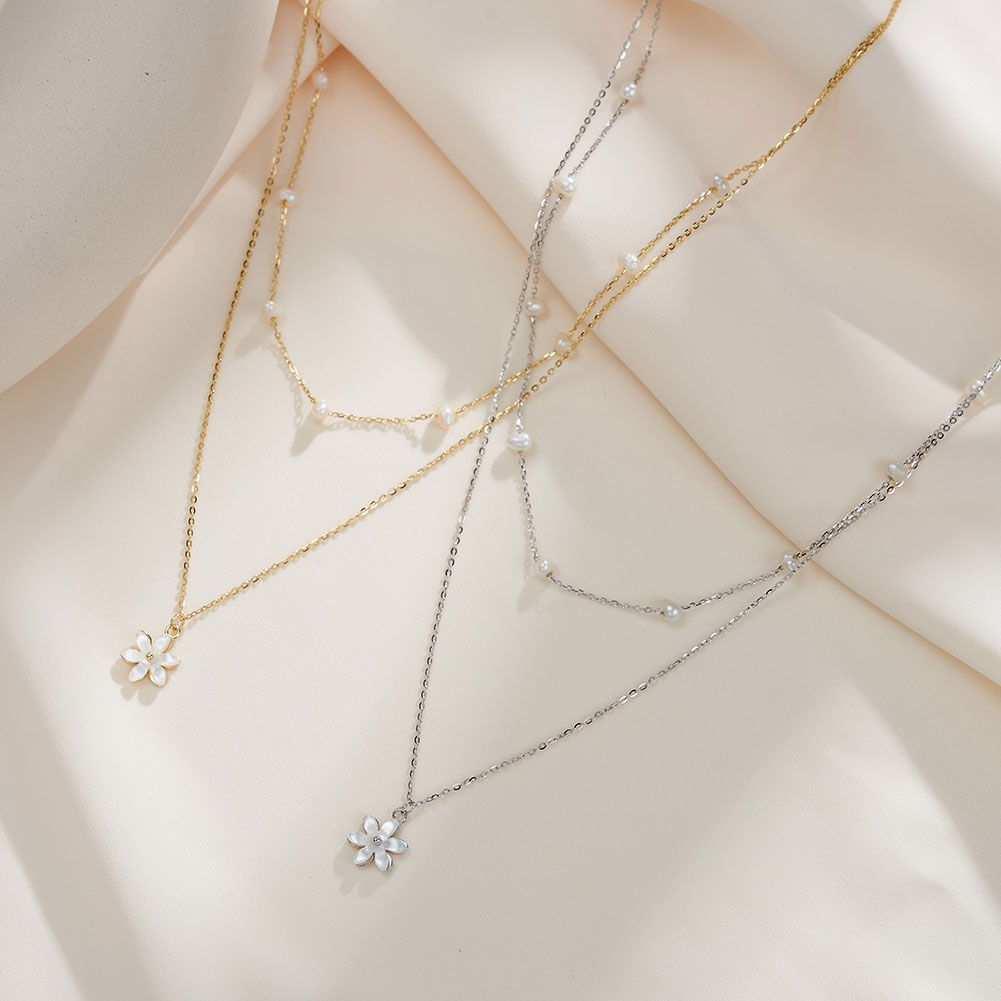 Layered pearl and flower pendant necklaces